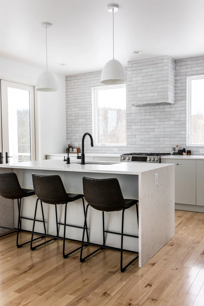 Eat-in kitchen - large scandinavian single-wall light wood floor and beige floor eat-in kitchen idea in Grand Rapids with an undermount sink, flat-panel cabinets, gray cabinets, quartzite countertops, gray backsplash, brick backsplash, stainless steel app