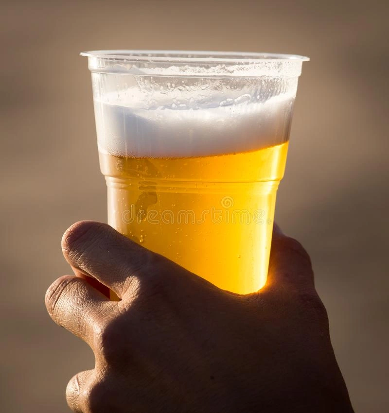 Fresh Beer in a Plastic Cup in the Hand Stock Photo - Image of table, hand:  106432800