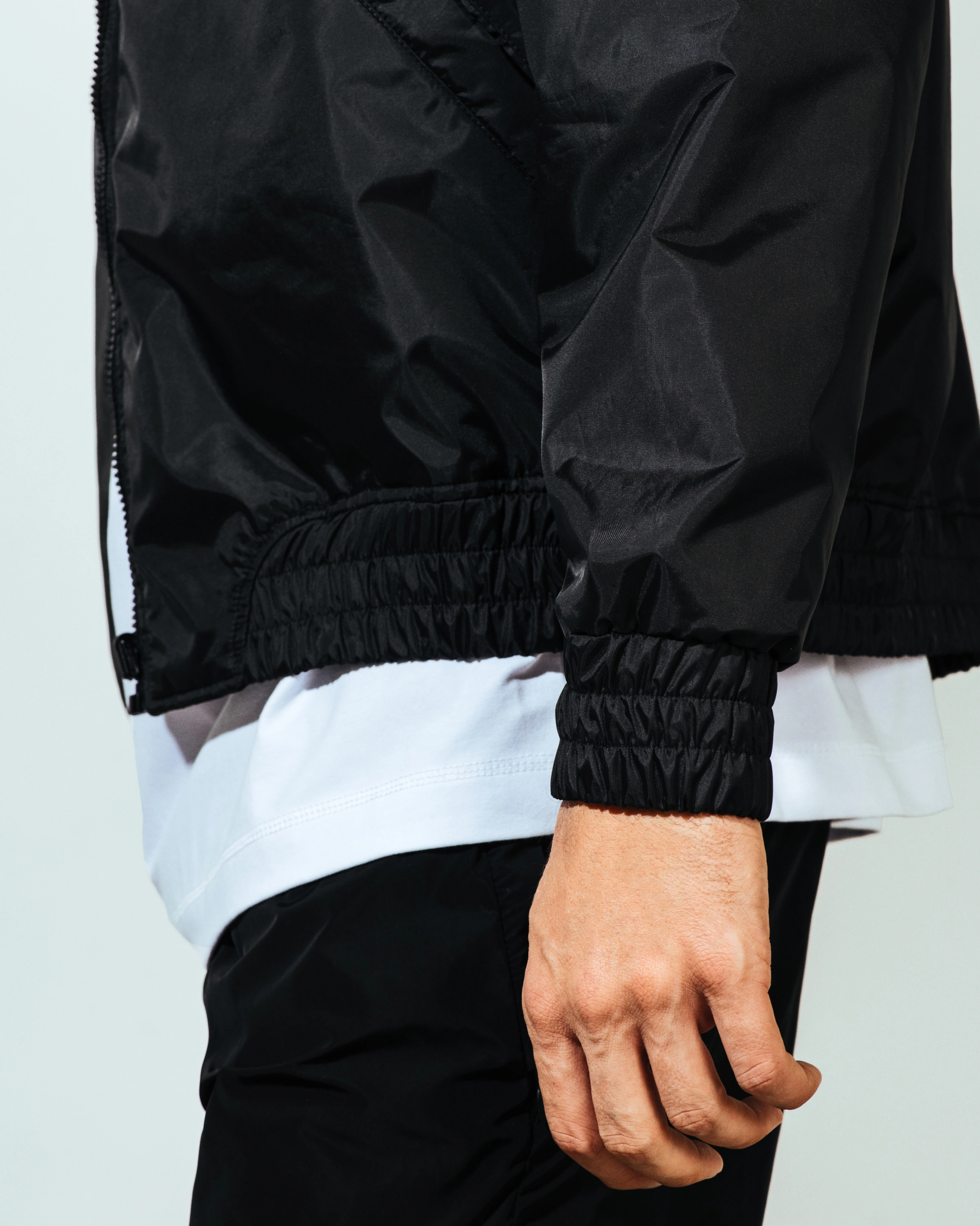 Black bomber jacket in nylon characterized by HW Studio embroidery at the back.