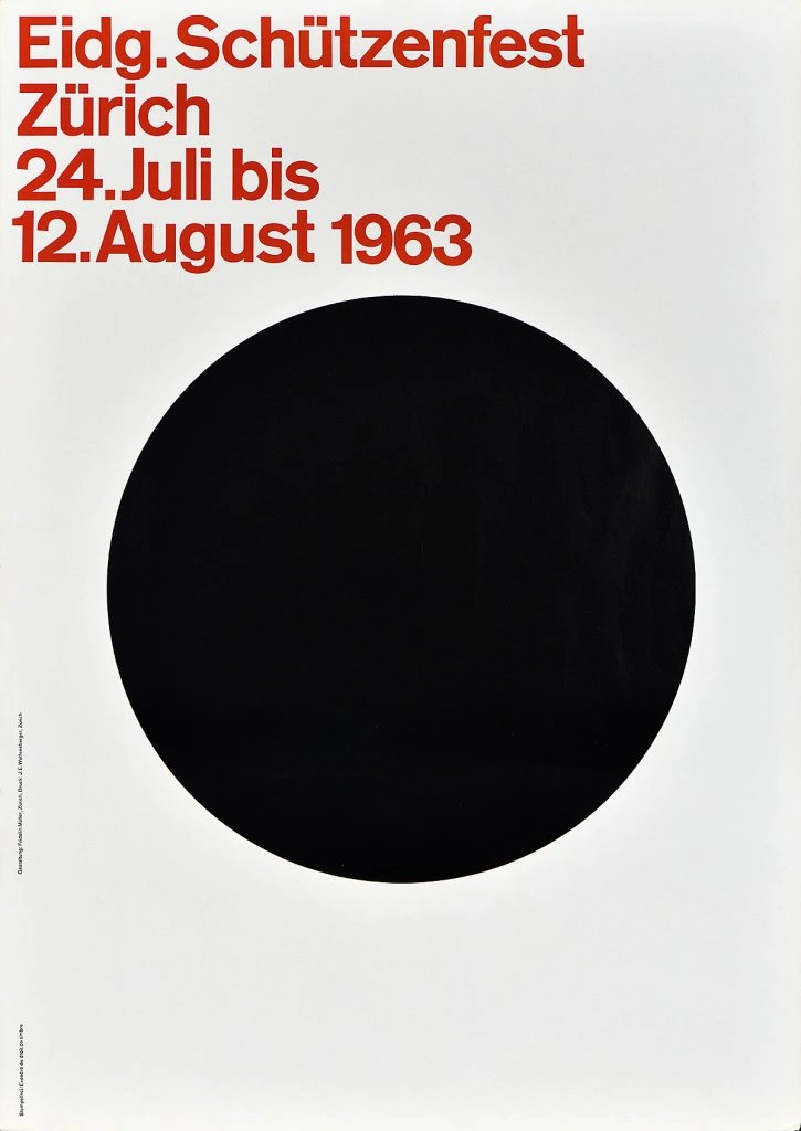 A photo offset poster of a large black circle on a white background with red text above it.