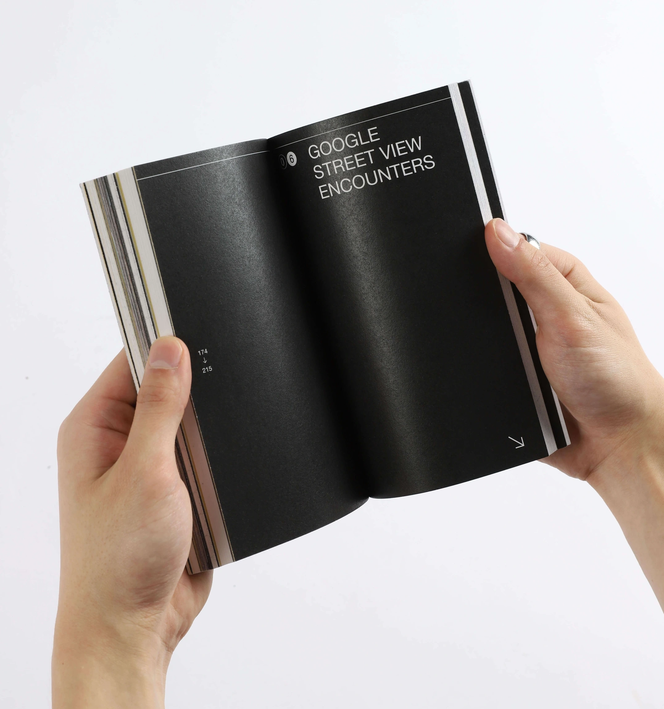 A spread of the book. The pages are black with an uppercase title in white &#x27;google street view encounters&#x27;.