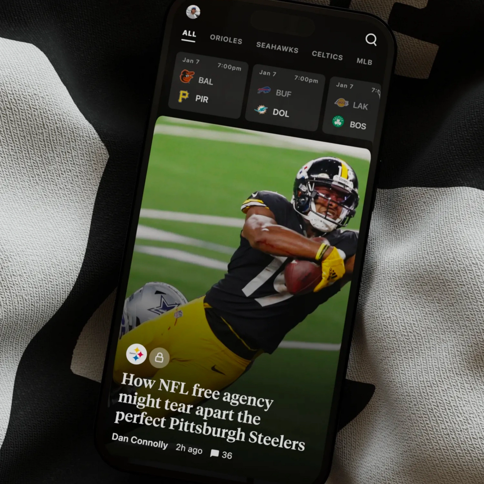 A Pittsburgh Steelers football player in action during a game being viewed from a mobile app