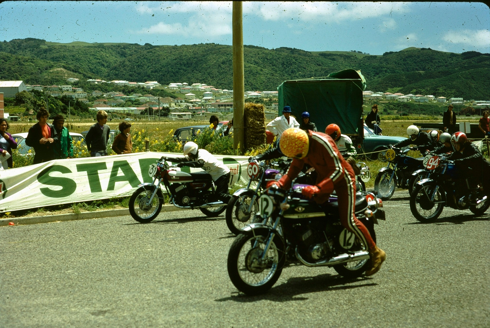 May be an image of 8 people, motorcycle and text