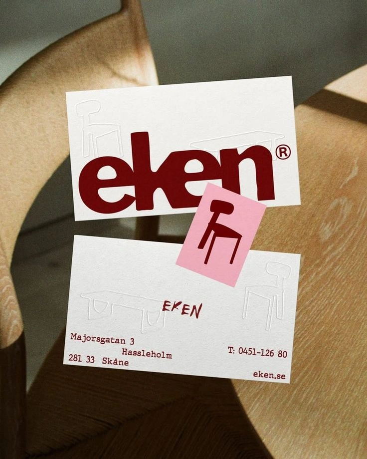 This may contain: a wooden chair with two business cards attached to it's back and the word een on top