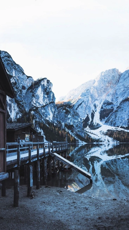 Lake Braies in the Prags valley in the northern Dolomites, Italy, surrounded by gorgeous mountains. Click through for 5 Italian lakes you can see that'll make any trip to Italy extra special. #Italy #Mountains #Lakes #Europe