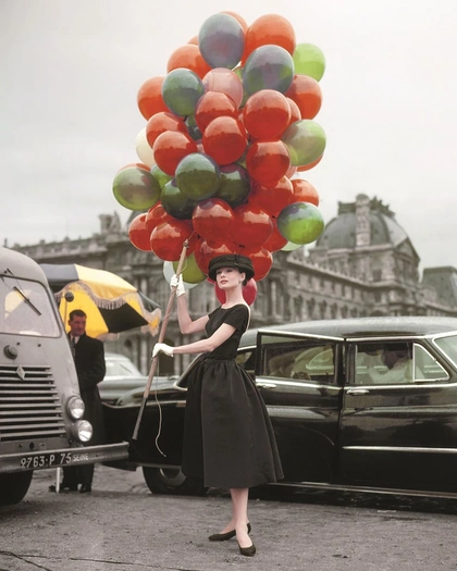 Audrey Hepburn wearing a dress by Givenchy posing on location at the Jardin des Tuileries in Paris while filming 'Funny Face', 1956. 