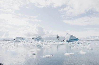 body of water under white sky at daytime