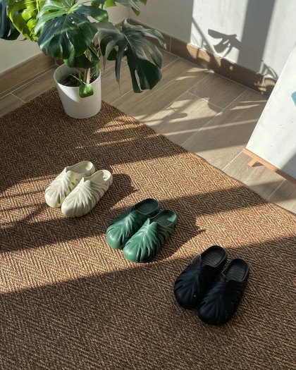 Photo by Unsent Studio on April 24, 2023. May be an image of espadrilles, welcome mat, house plant, sandals, carpet and text.