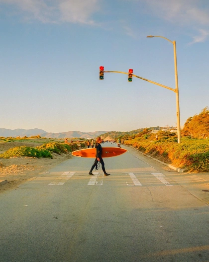 Photo by Kodak on February 11, 2024. May be an image of 3 people, skateboard, surfboard, road, telephone pole, lamppost and curb.