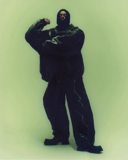 Photo shared by Silver Tooth on March 07, 2024 tagging @clashmagazine, @serpentwithfeet, and @keithoshiro. May be an image of 1 person, standing, face mask, sweatsuit, parka, snowsuit and gas mask.