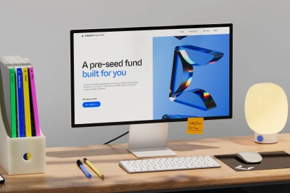 A monitor on a table with concept ventures homepage on it