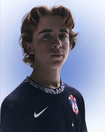 Gavin Bottger looking into the camera while wearing his USA skate kit uniform.