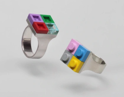 two sterling silver rings designed by Studio GOGO featuring colorful LEGO bricks stuck to the top